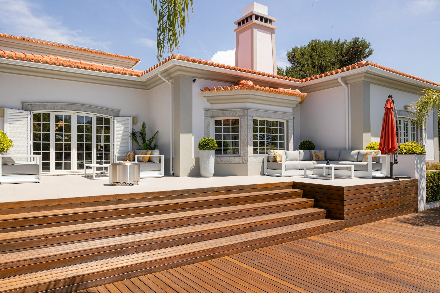 A beautiful house with decking and an outdoor patio.