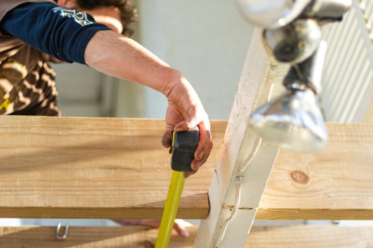 Worker holding black and green power tool