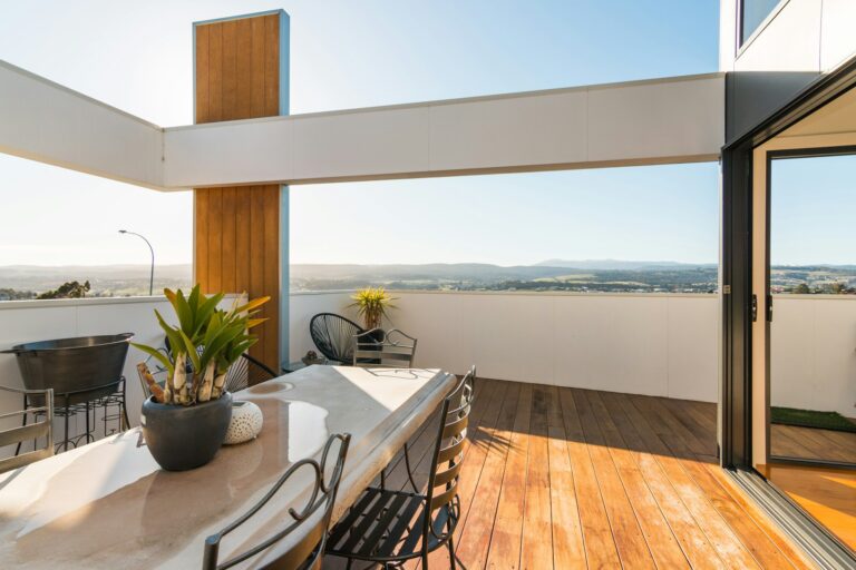 Exterior wooden deck with table and open outdoor view