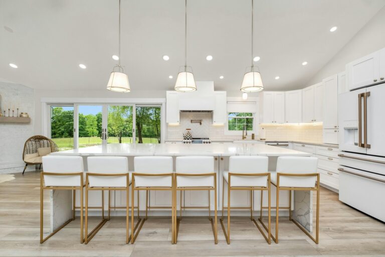 A large kitchen with a center island and white cabinets