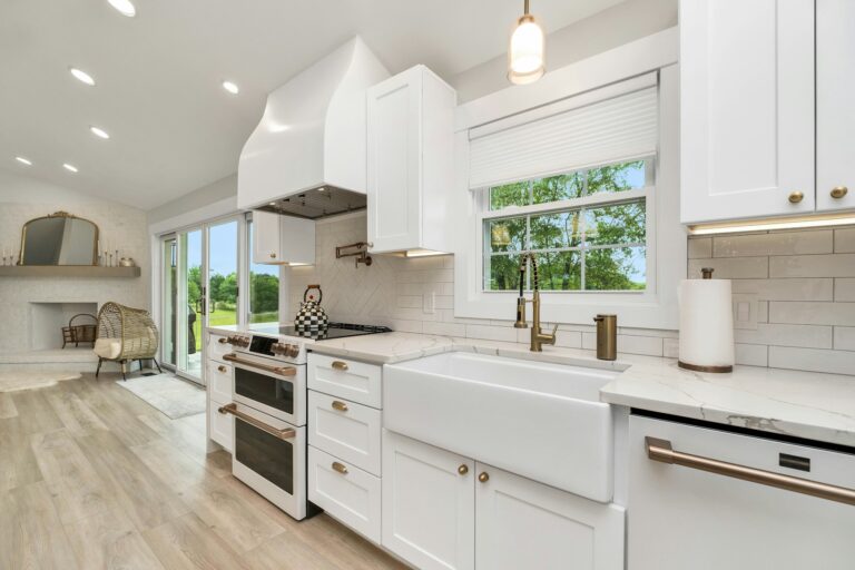 A kitchen with island and white cabinets