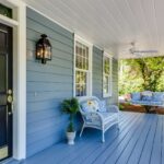 A porch with two chairs and a table