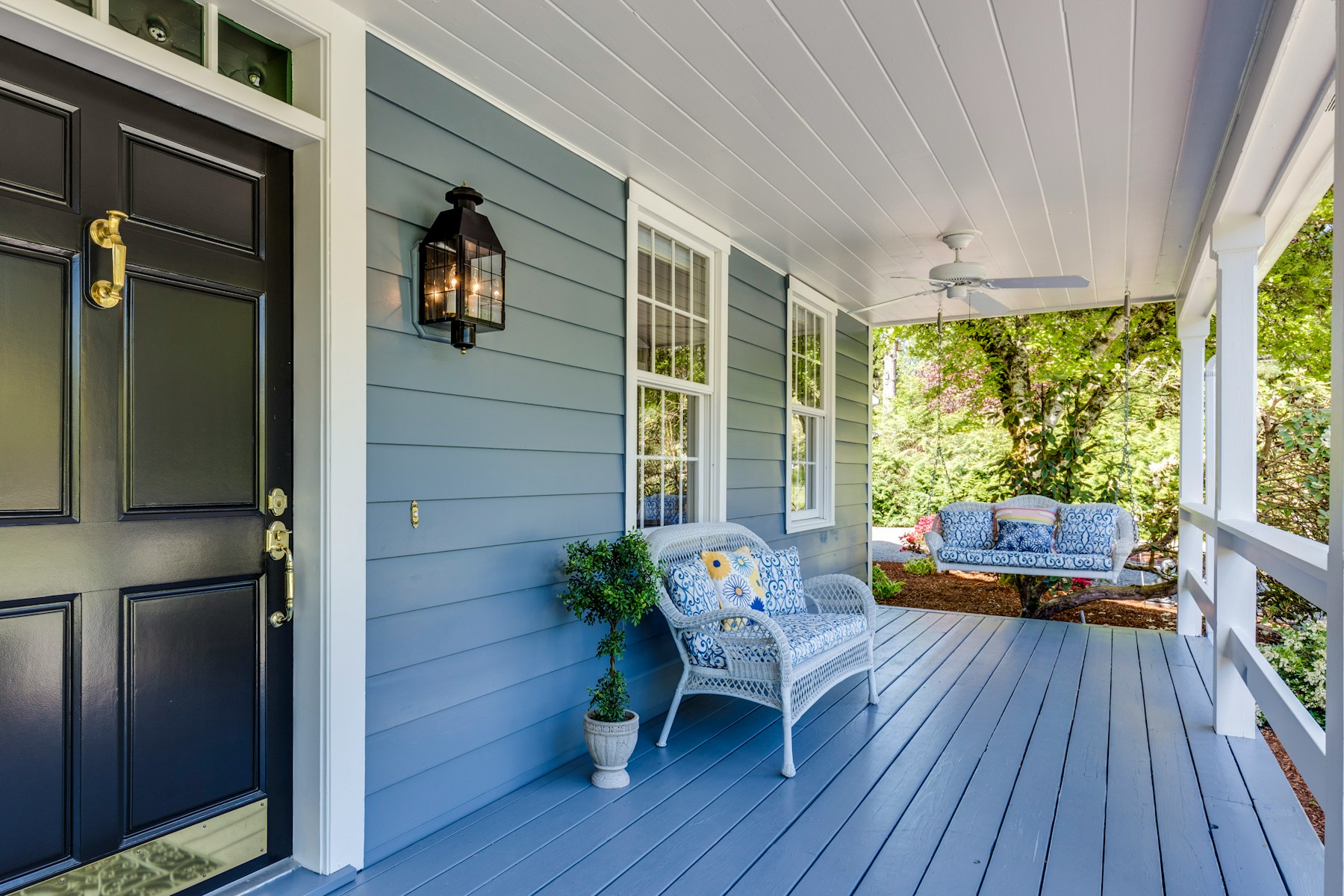 A porch with two chairs and a table